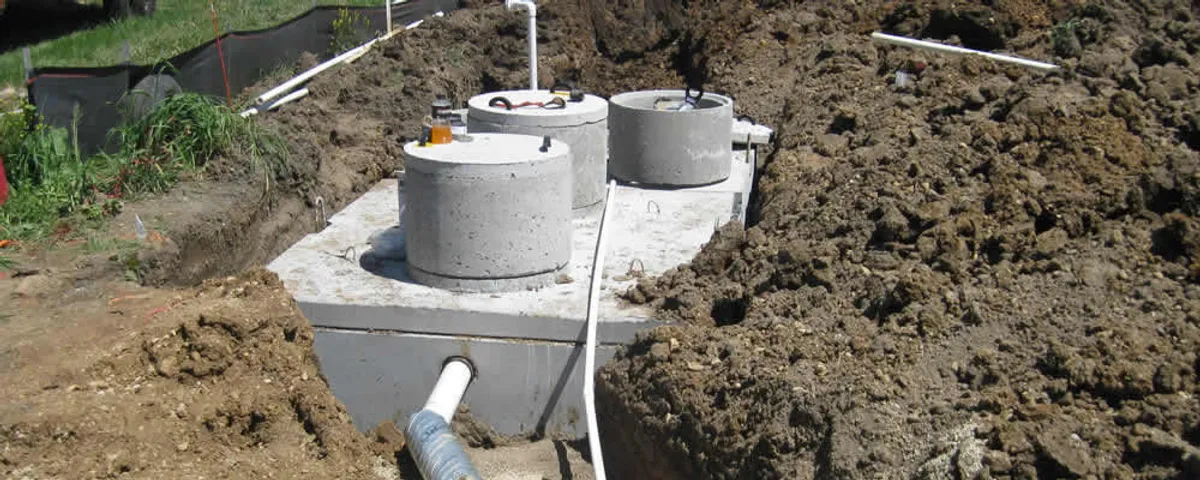 Septic system repair and installation site with tank access ports in Olathe, KS